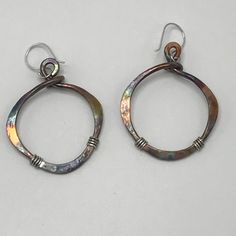 "These bronze earrings are hammered and given a patina finish for a rustic look. Mixed metal of bronze and sterling silver have a nice two tone effect. These earrings are very rustic and earthy and make a unique statement. They measure 1 3/4\" Long. Approximate measurements without an ear wire attached: 1 1/8\" widest part x 1 5/16\"high -(29mm widest part x 33mm High). These are also available in a larger version-see link below. The patina effect gives these earthy earrings lots of color. Every Artisan Small Hoop Copper Jewelry, Everyday Silver Copper Earrings, Everyday Copper Dangle Earrings, Hand Forged Copper Dangle Hoop Earrings, Hand Forged Copper Hoop Earrings With Dangle, Artisan Copper Dangle Hoop Earrings, Nickel-free Small Hoop Copper Jewelry, Handmade Copper Teardrop Hoop Earrings, Artisan Nickel Free Copper Hoop Earrings