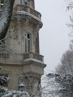 an old building with snow on the ground