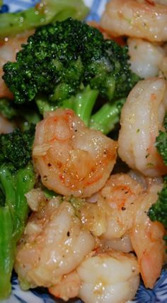 shrimp and broccoli on a blue and white plate