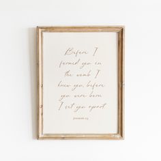 a wooden frame with a handwritten poem on it hanging on the wall next to a white wall