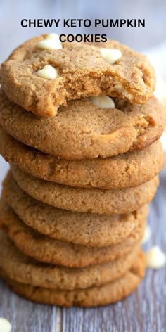 chewy keto pumpkin cookies stacked on top of each other with white chocolate chips