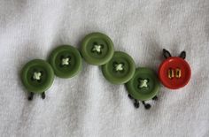 four green buttons with holes in the middle on a white surface, one red and one green