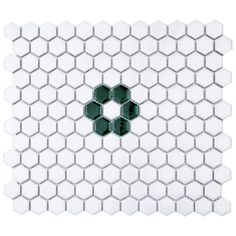 the white and green hexagonal tiles are arranged in an intricate pattern, with one letter