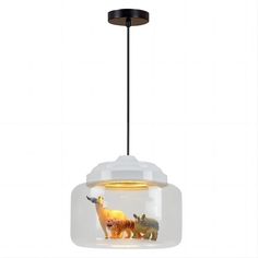 an animal lamp hanging from a ceiling fixture with two animals in the glass bowl on top