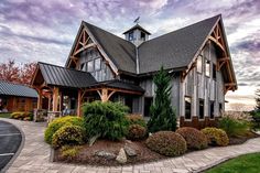 a large house with lots of windows on the front and side of it's roof