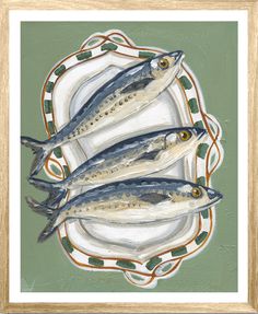 three fish are sitting on a plate with green and red trimmings, in a gold frame