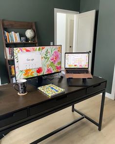 a desk with two laptops and a desktop computer on it