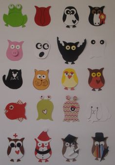 an assortment of cut out animals on a white surface with black and red ones in the middle