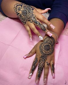 two women with henna tattoos on their hands