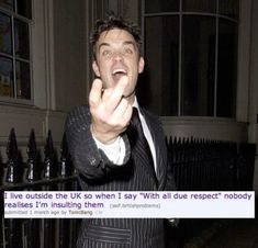 a man in a suit pointing his finger at the camera with an instagram message below him