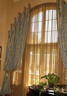 a living room filled with furniture and curtains