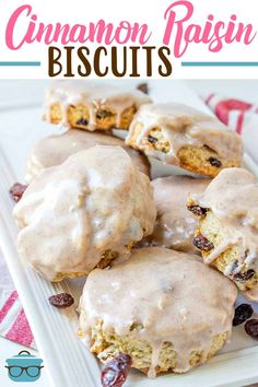 a white plate topped with donuts covered in frosting and raisin toppings