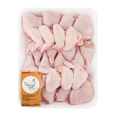 raw chicken pieces in a plastic container on a white background with a label for the product