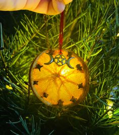 an ornament hanging from a christmas tree with the moon and stars on it