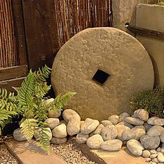 a garden with rocks and plants around it