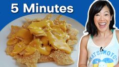 a woman is smiling next to a plate of nachos with cheese on it