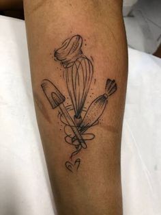 a tattoo on the leg of a person with a knife and spatula in it