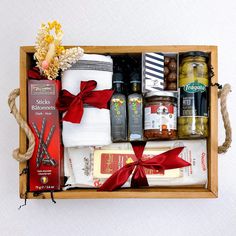 a wooden box filled with different types of food and condiments on top of each other