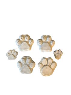 four different sized paw prints on a white background