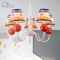 a basketball themed chandelier hangs from the ceiling in a child's room