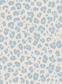 a blue and white animal print wallpaper with spots on the side, in shades of light blue