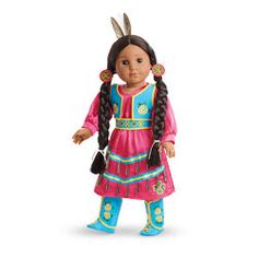 an american girl doll with long black hair wearing a pink dress and blue boots, standing in front of a white background