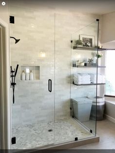 a bathroom with a walk in shower next to a toilet