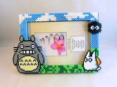 a photo frame made out of legos with an image of a totoro and a flower