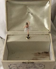 a small figurine in a white box