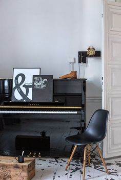 a black piano sitting in the corner of a room