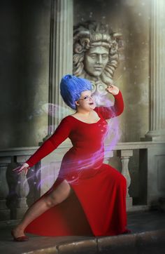 a woman in a red dress and blue hair