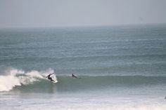 two surfers are riding the waves in the ocean