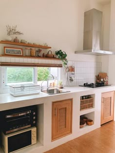 a kitchen with wooden cabinets and white counter tops next to a stove top oven under a window