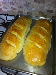 two loaves of bread sitting on top of a pan