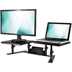 a laptop computer sitting on top of a desk next to a desktop computer monitor and keyboard