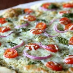 a pizza with tomatoes and onions on it