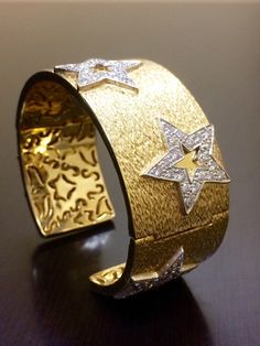 DeKara Designs Collection Metal- 18K Yellow Gold, .750, 96 Grams. Stones- 100 Round Diamonds G Color VS1 Clarity 5.03 Carats. Measurements- 1 Inch Wide, 4.22 MM Thick, Stars are 21 MM x 21 MM. Entirely handmade heavy 18K Yellow Gold Diamond Star Cuff Bracelet. This bracelet has 5 white gold stars that have 20 pave diamonds on each start that have been hand assembled onto the bracelet itself. The gallery inside of the bracelet has all separately made with starts and other scroll work that gives t Luxury Star-shaped Formal Jewelry, Luxury Star-shaped Jewelry For Formal Events, Luxury Gold Star Bracelets, Luxury Gold Star Bracelet, Bangle Diamond, 18k Gold Bangle, Diamond Cuff Bracelet, Diamond Bangle Bracelet, Scroll Work