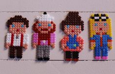 the bead art is made to look like legos and are hanging on a wall