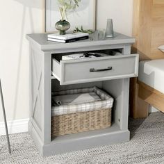 a gray nightstand with baskets on the bottom shelf