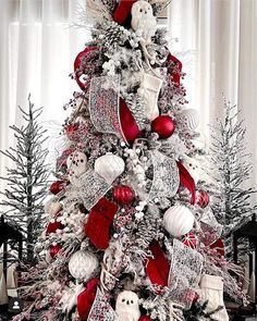 a christmas tree decorated with red and white ornaments