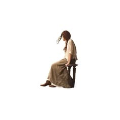 a woman sitting on top of a wooden chair