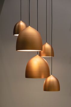 three gold colored lights hanging from the ceiling