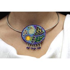 a woman wearing a beaded necklace with a colorful design on the front and back