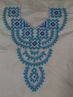 a blue and white piece of cloth with designs on it