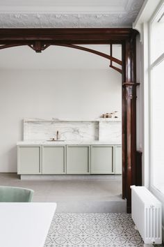 an instagramted photo of a kitchen with white cabinets