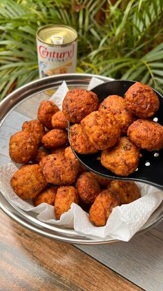 there are some fried food on the table next to a can of soup and two spoons