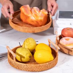 two baskets filled with fruit sitting on top of a counter