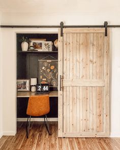 an office with a desk and wooden doors