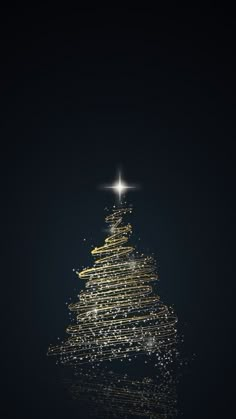 a christmas tree made out of lights on top of a dark surface with the star above it