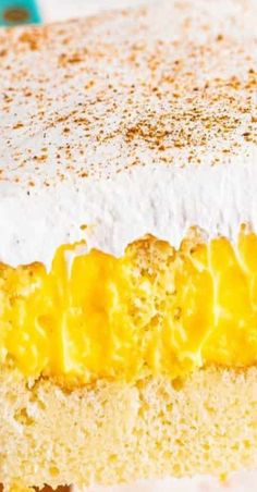 a close up of a cake with yellow and white frosting